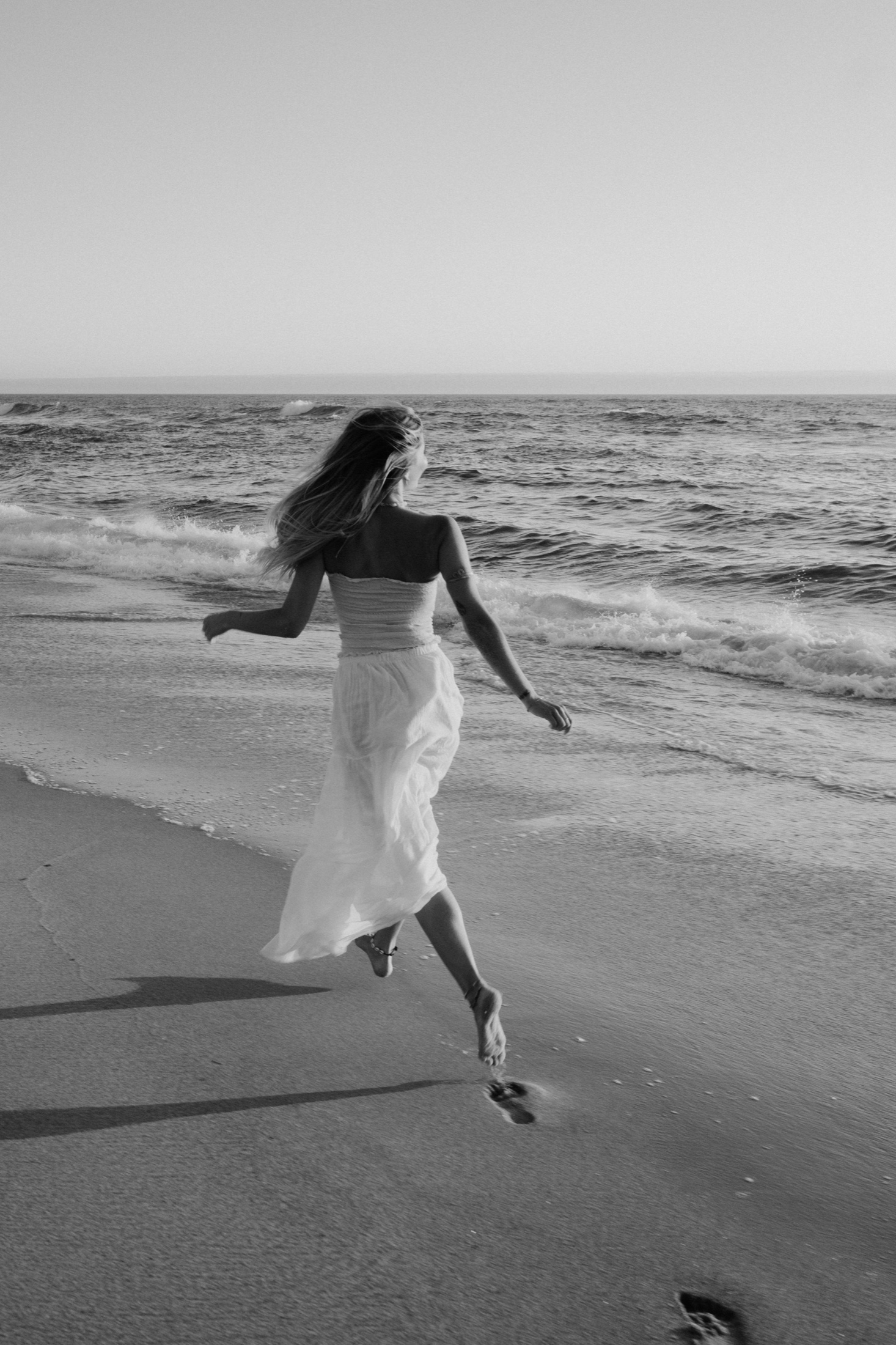 Amelia standing in the water at dusk