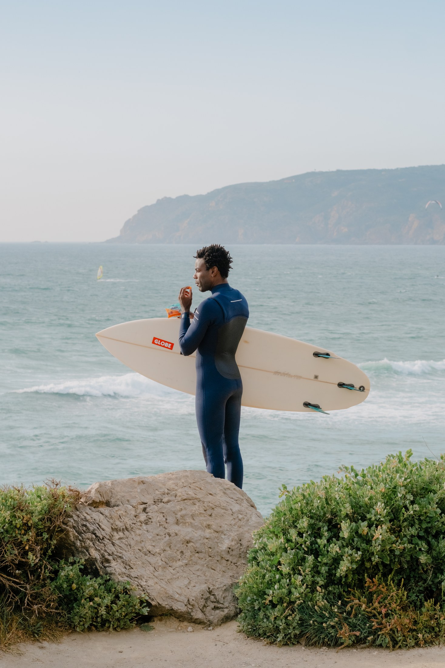 Surfer framed by the path to the ocean