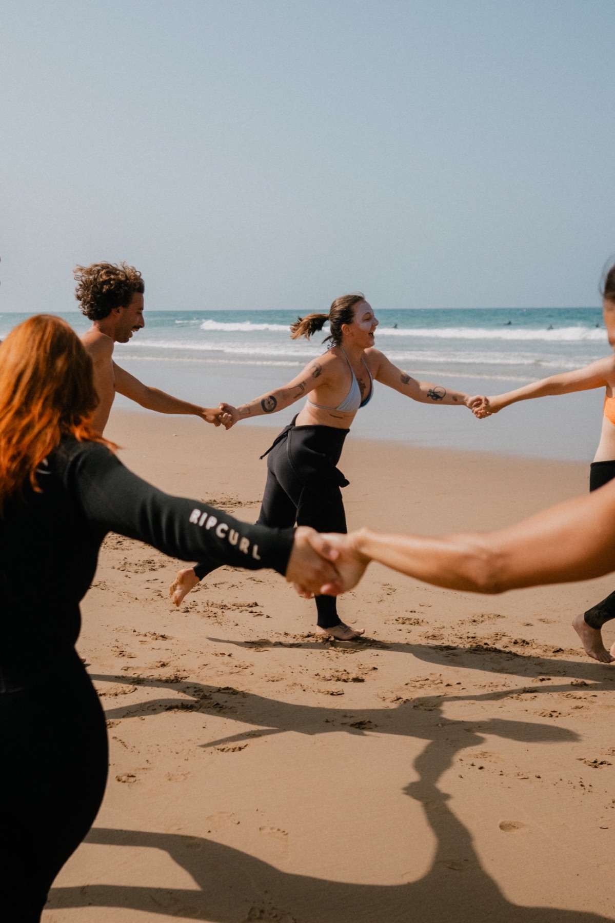 The group warming up together on the beach