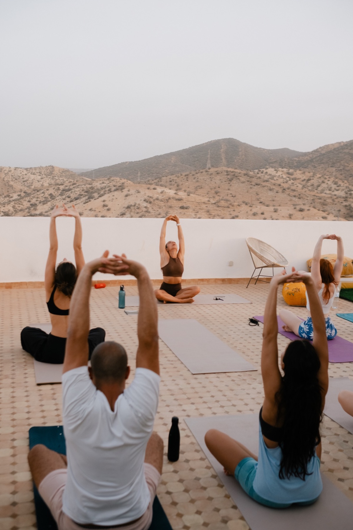 A yoga session beside the pool at Surf Villa Morocco