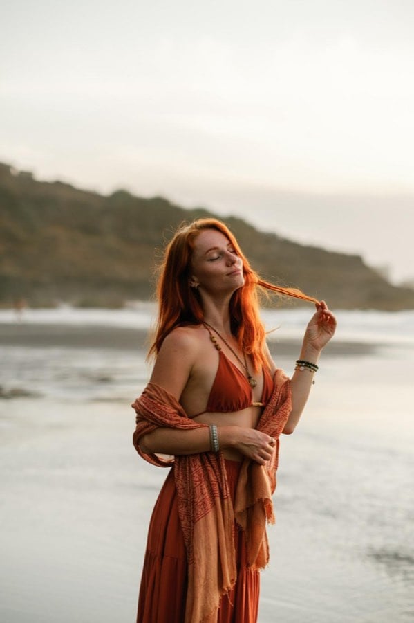 Warm golden-hour portrait beside the coast