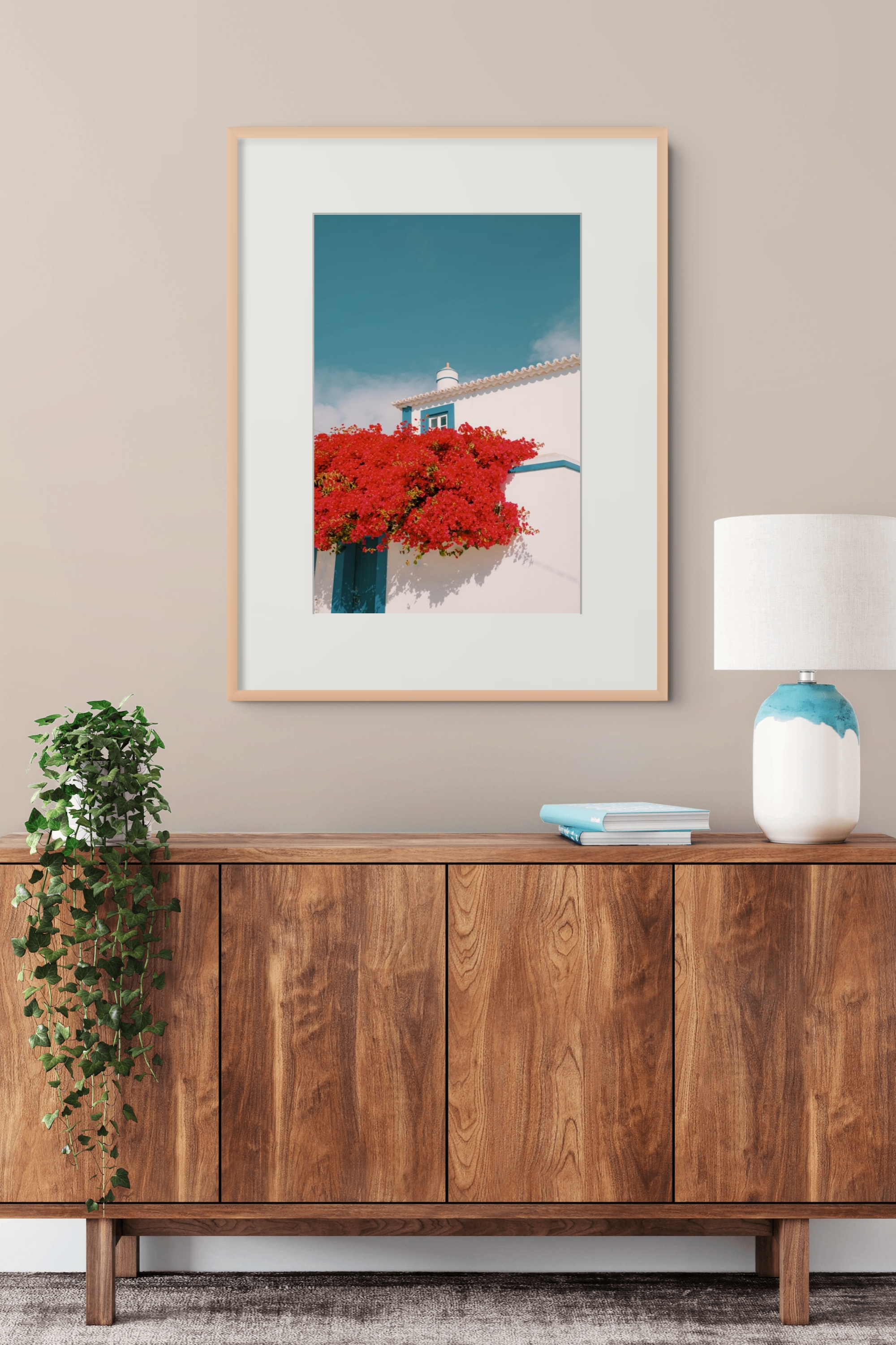 Colorful architectural print displayed above a wooden cabinet