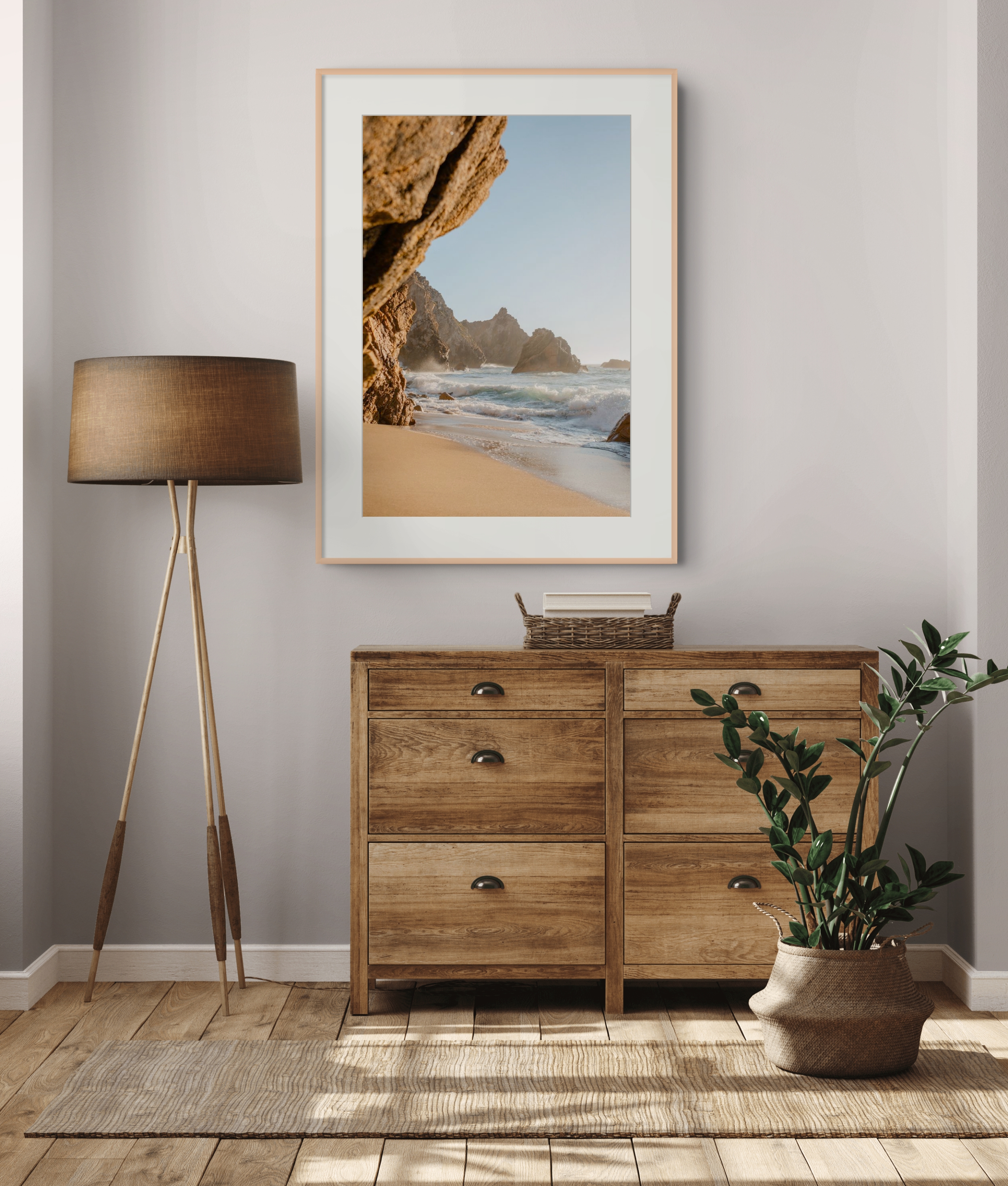 Coastal print displayed above a wooden chest