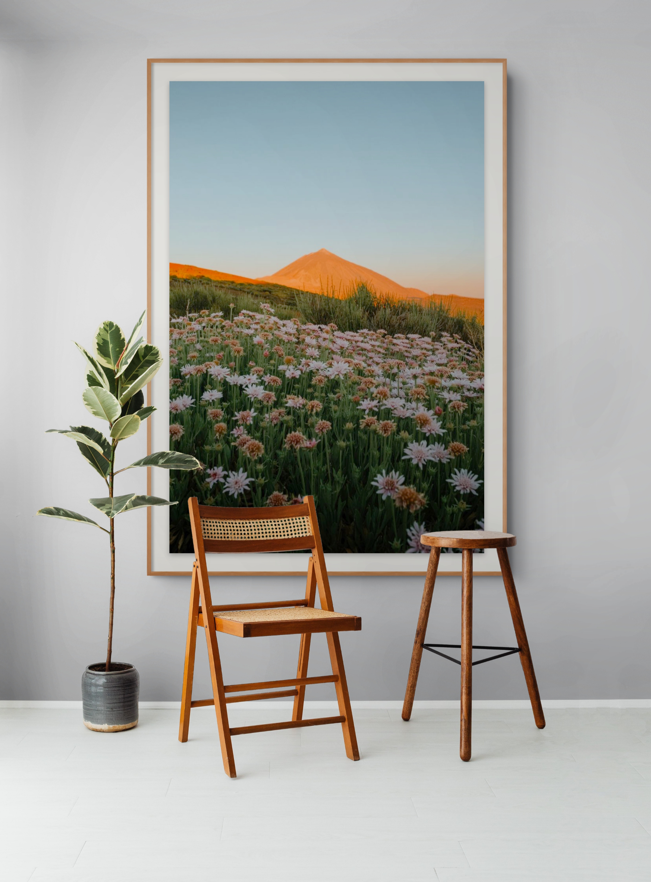 Mountain and flowers print displayed in a minimal interior