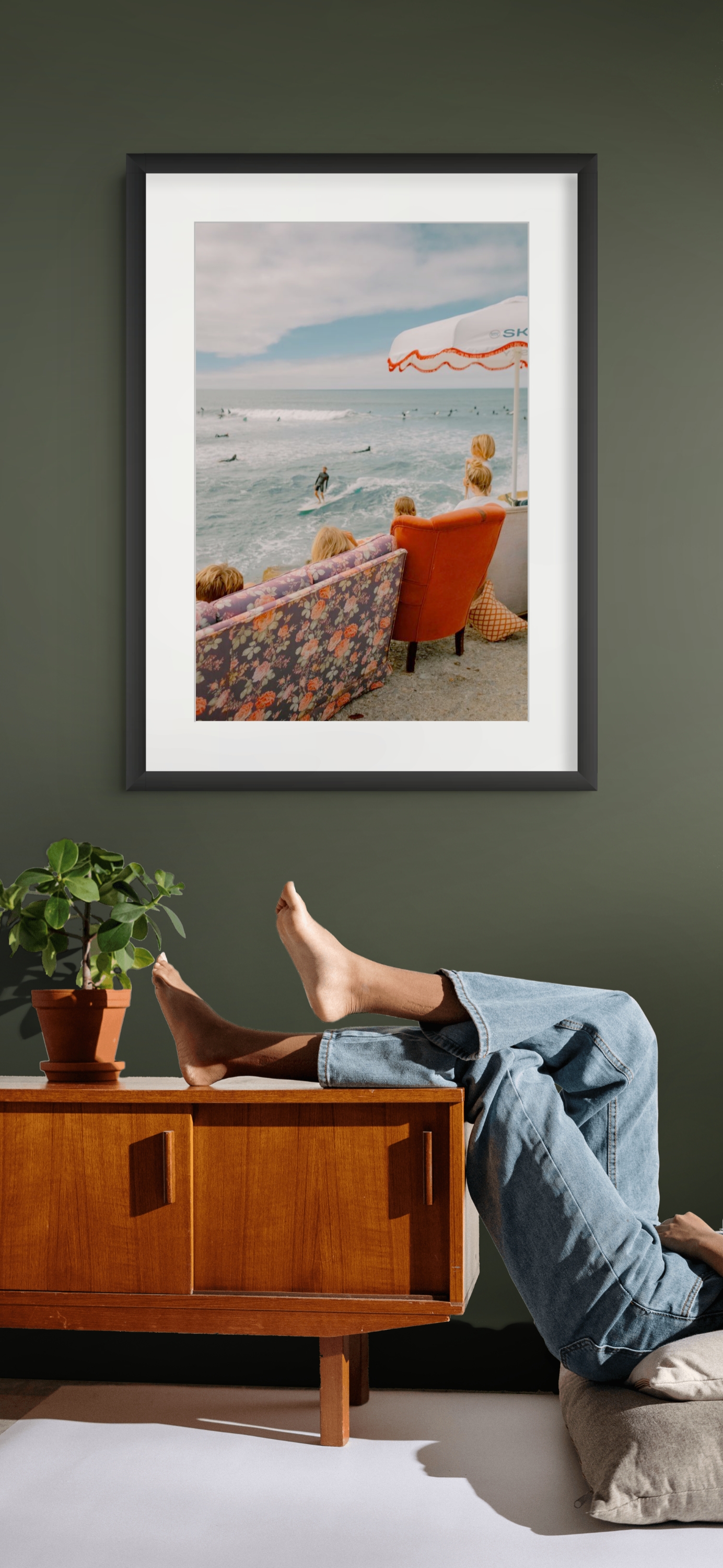 Surf scene print displayed above a wooden cabinet